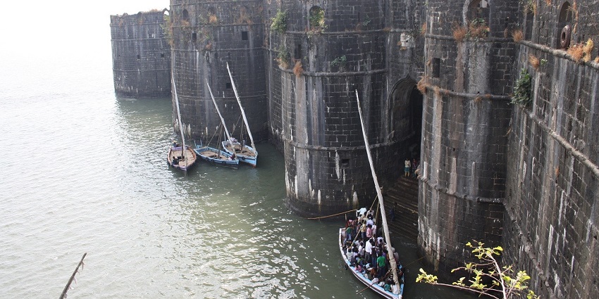 View of the fort aligning with a river with small boats sailing in it