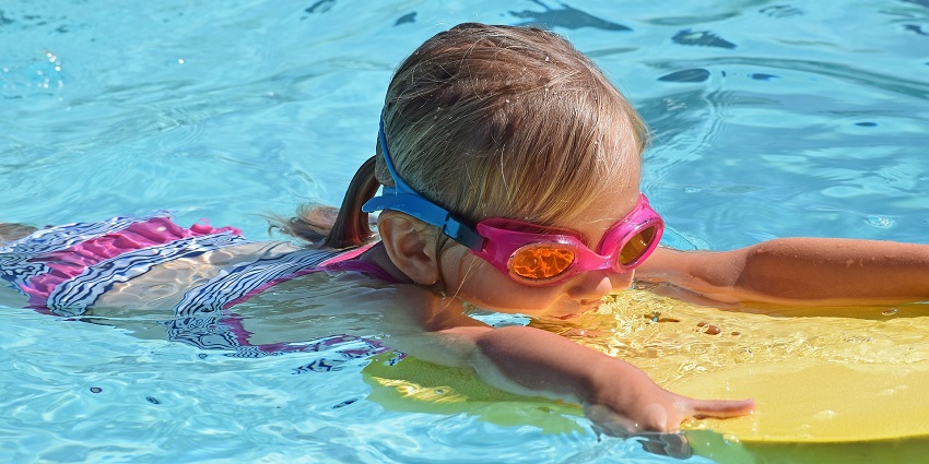A view of a child floating on the water in a water park near Wardha having a fun time.