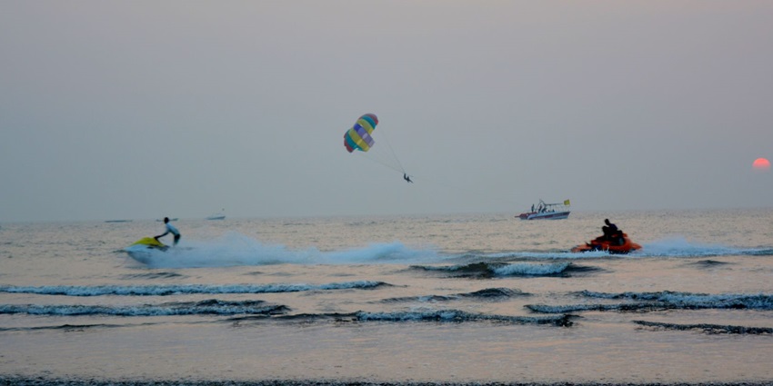 View of Nagaon Beach with golden sands and green surroundings.