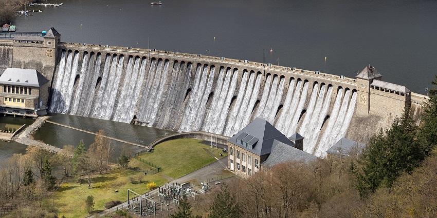 A panoramic view of Nagchun Dam surrounded by lush greenery and serene waters.