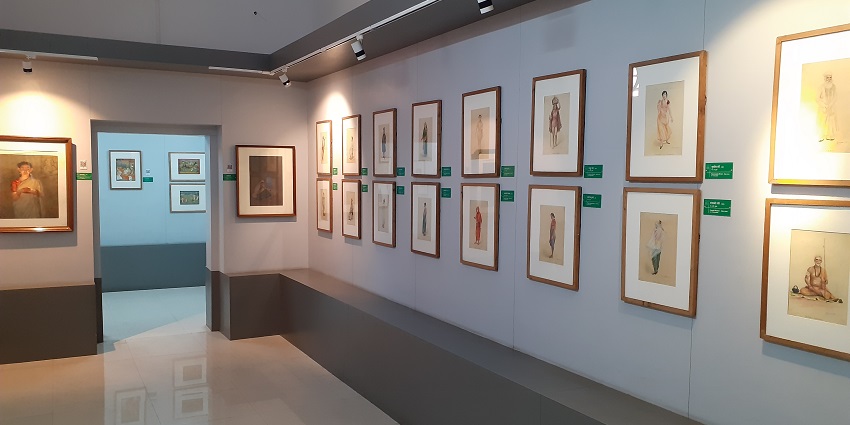 A wide view of the Nagpur Central Museum's painting gallery, showcasing various artworks on the walls.