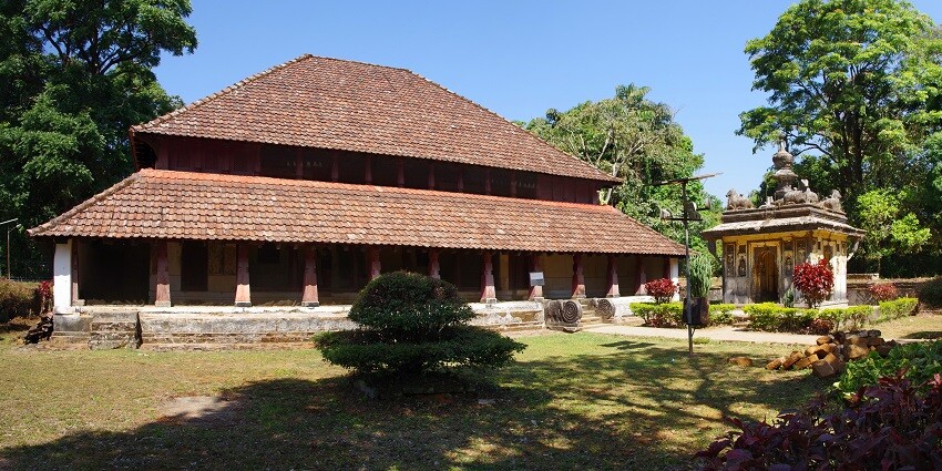 Exterior view of Nalknad Palace, showcasing traditional architecture in a scenic setting.