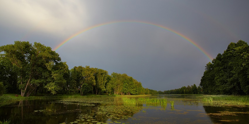 A beautiful rainbow over the lake during daytime, just 5 km from Nandi Hills.