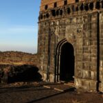 Narayangad Fort in Maharashtra is surrounded by lush greenery and mountains.