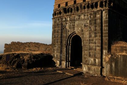 Narayangad Fort in Maharashtra is surrounded by lush greenery and mountains.