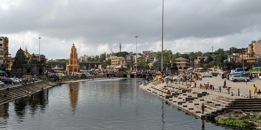 A glimpse of the bustling beauty of Nashik featuring serene water and tranquil temples.