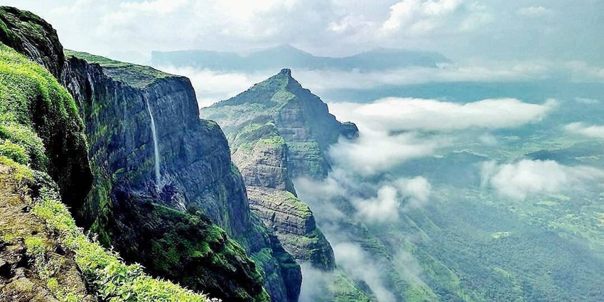 A breathtaking vista of Nashik featuring towering mountains and lush greenery.