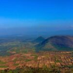 A panoramic view of Tamil Nadu, India, capturing a scenic landscape and rolling green hills.