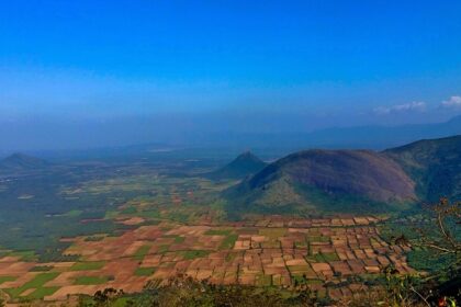 A panoramic view of Tamil Nadu, India, capturing a scenic landscape and rolling green hills.