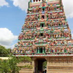 A temple, showcasing its intricate architecture and traditional design with blue sky behind.