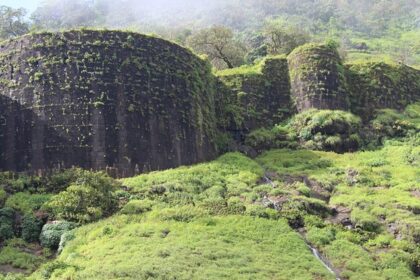 Scenic view of Navra Navri Cha Dongar hill with lush greenery and clear skies.