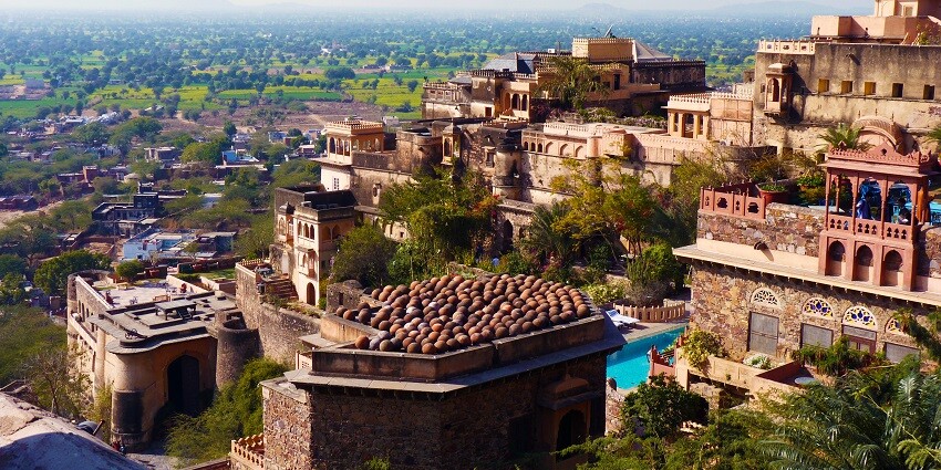 Neemrana Fort Palace, a grand 15th-century stone structure, is a must-visit attraction.