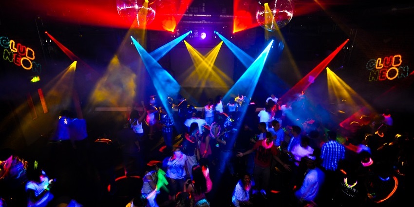 A glimpse of rave party in Bangkok featuring neon lights and jungle-themed decorations.