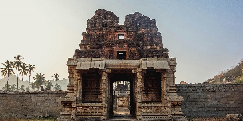 Ancient temple with intricate carvings illuminated by the warm light of sunrise.