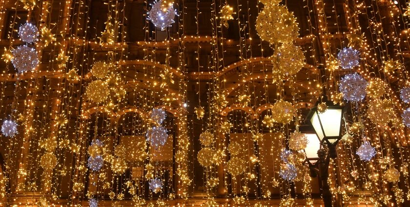 A glimpse of dazzling yellow lights hanging from a hotel at night for big celebrations.