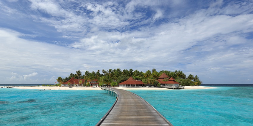 Celar views of the beautiful island resort surrounded by the lush palm tress and blue lagoon