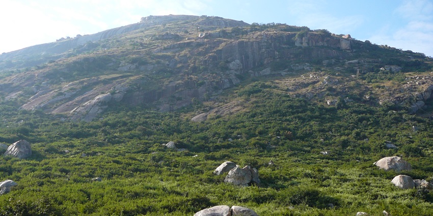 Mist-covered hills and rugged terrain of Skandagiri near Bangalore, popular for treks.