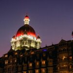 A beautiful picture of a hotel taken during nighttime, lit up with lights up the dome