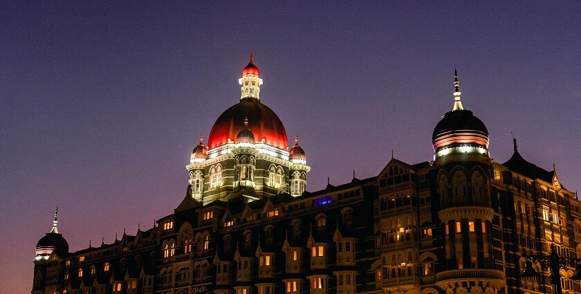 A beautiful picture of a hotel taken during nighttime, lit up with lights up the dome