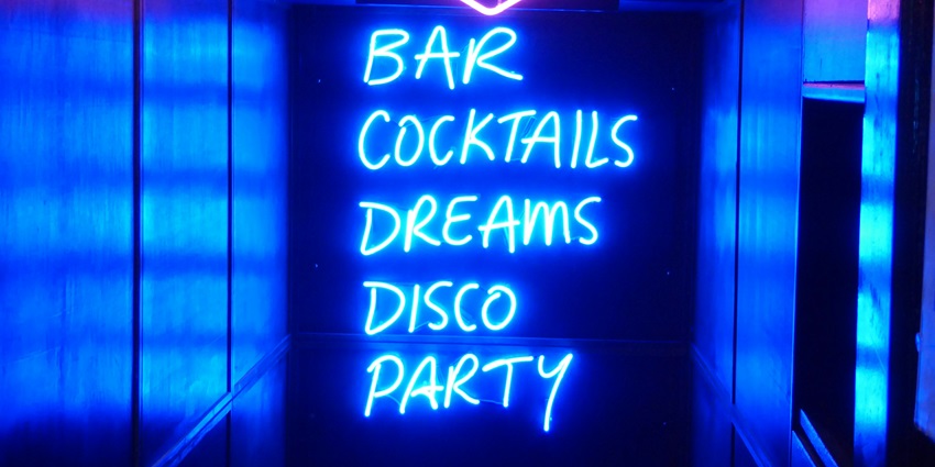 Vibrant nightlife in South Tukoganj with dance parties, DJs, and an energetic crowd.