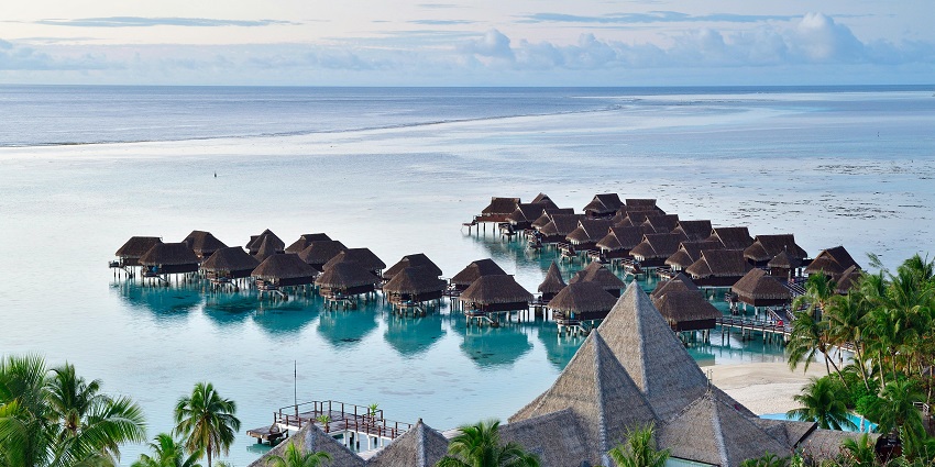 An image of the luxurious beach area in Nusa Dua with resorts and clear waters.