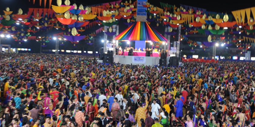 An image of Garba dancers and devotional music performances at the OM Ram Ayodhya Garba Festival.