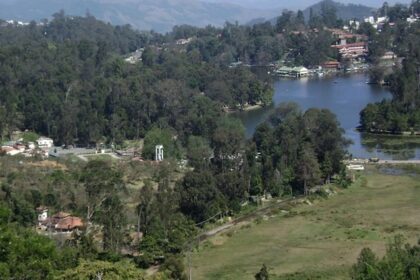 View of Kodaikanal Lake surrounded by hills and trees in Kodaikanal.