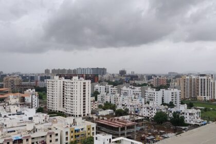 A shot of the Pune skyline with modern buildings and greenery during the day