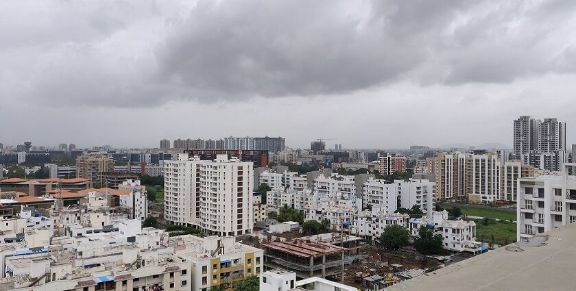 A shot of the Pune skyline with modern buildings and greenery during the day