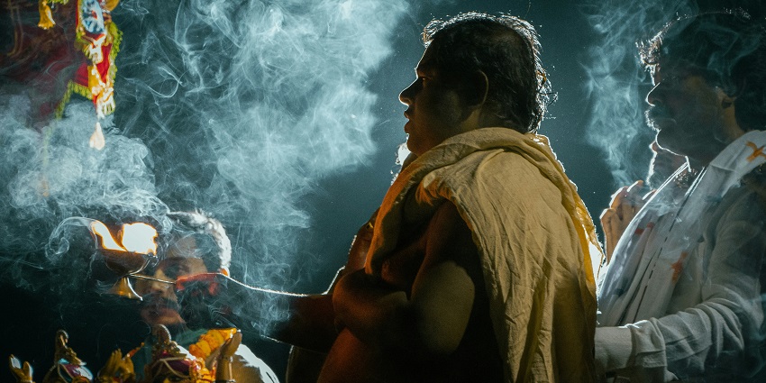 A man standing in front of a group, discussing Balumama Temple and its significance.