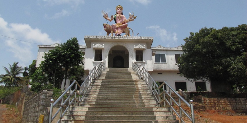 A picture of a stairway leading to a historical Hindu temple with an idol of a Hindu Goddess