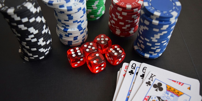An image of Poker chips at a casino in Delhi with slot machines and gaming tables.
