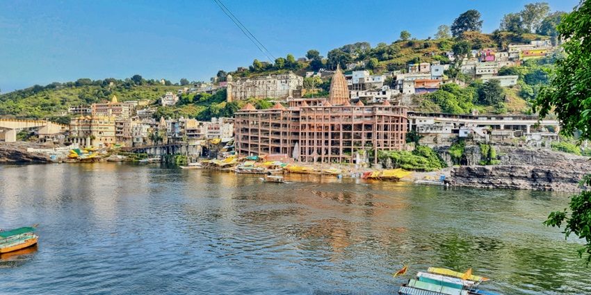 Omkareshwar Jyotirlinga Temple with ornate domes and steps along the river