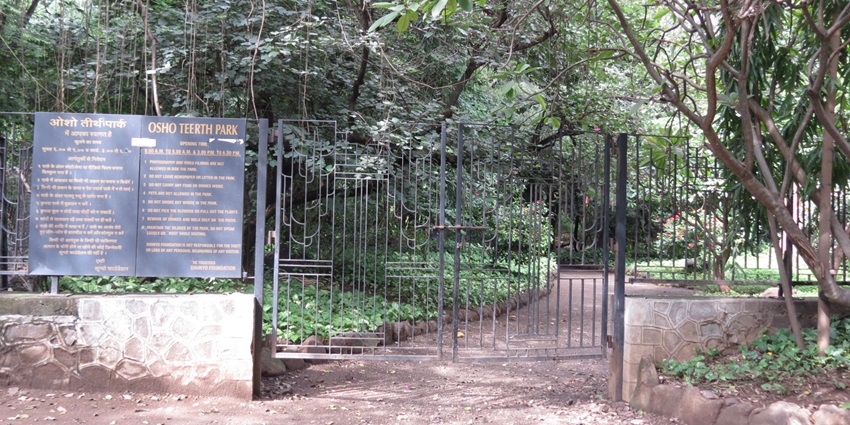 Serene view of Osho Teerth Park with lush greenery and tranquil pathways.