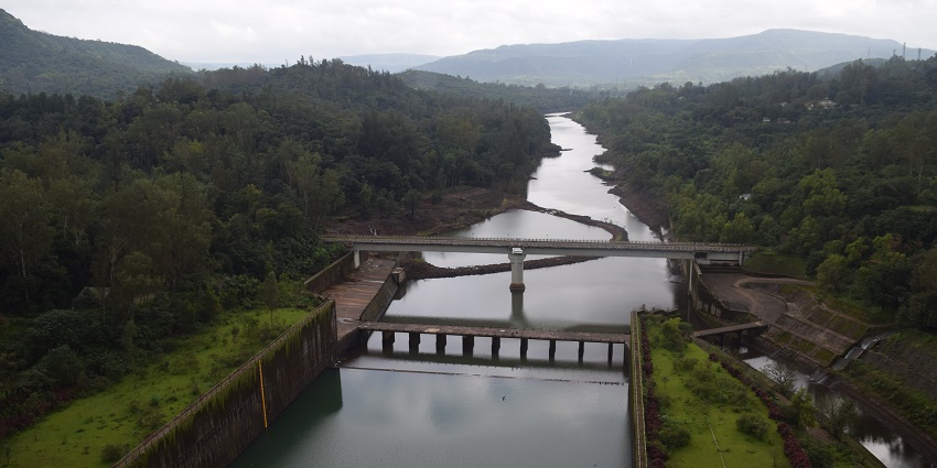 View of the Koyna Dam spillway and canal, showcasing the structure and surroundings.
