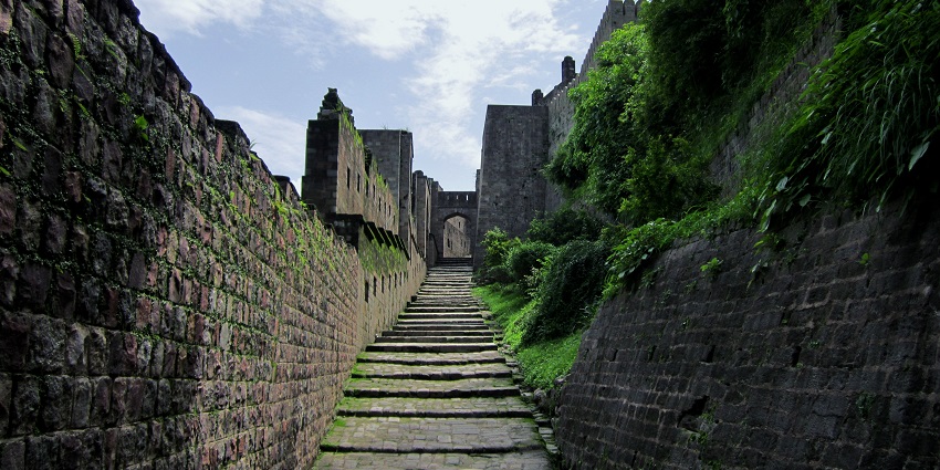 Tabular-shaped steps leading to a fort gate which is surrounded by thick stone walls