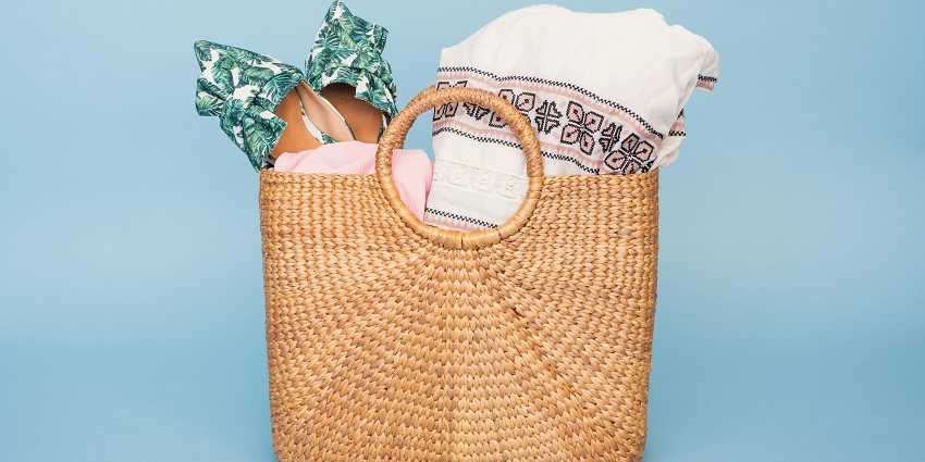 Image of basket perfect for picnic and beach day with footwear, and beach wears in it