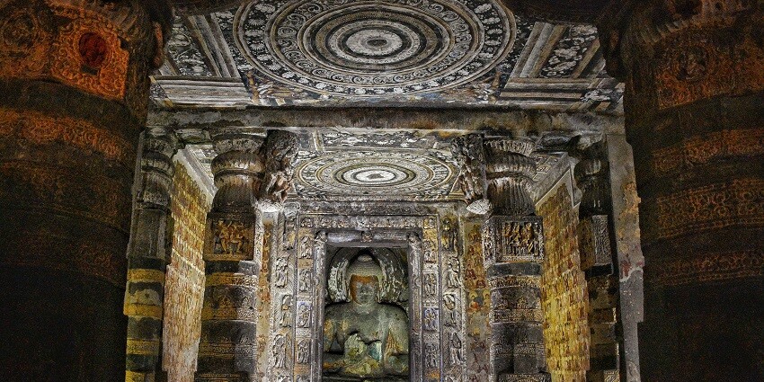 Inside the majestic halls if the caves with a big idol in the center and intricately carved pillars
