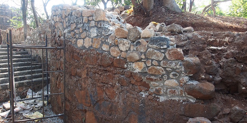 Stone walls and towers visible under clear skies.