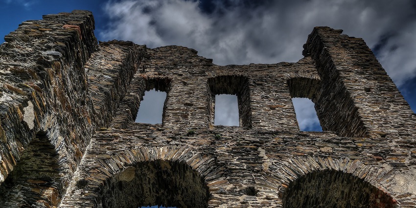 Ancient Fort ruins with stone walls and arches set against a cloudy sky