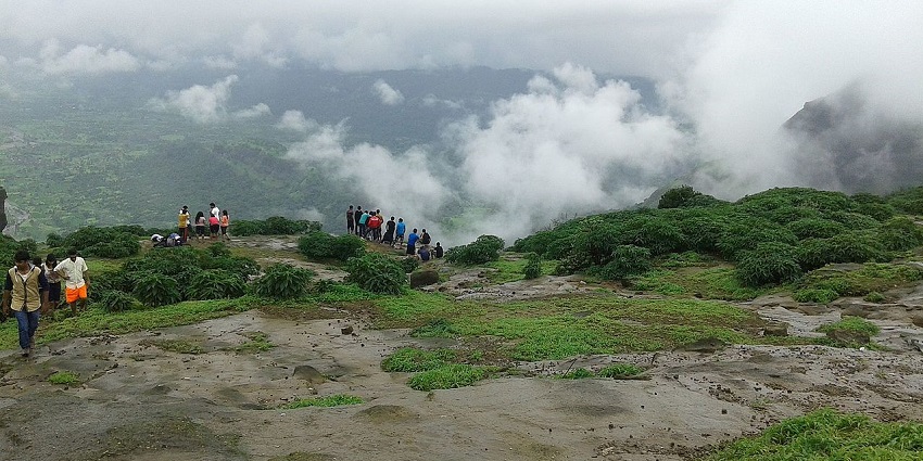 People enjoying the view and monsoon weather of Lonavala from the hilltop covered in mist