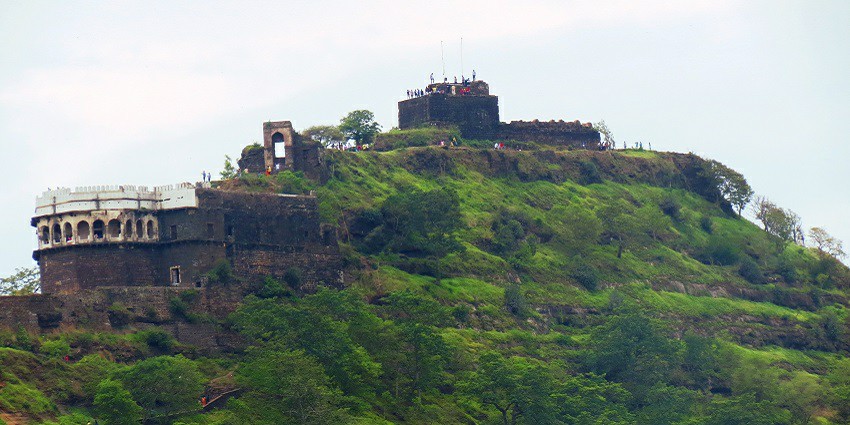 View of the fort surrounded by lush greenery atop the hill