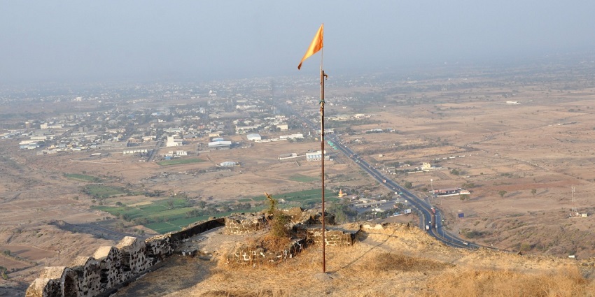 A view of Laling Fort features ancient stone walls and greenery in Maharashtra, India.