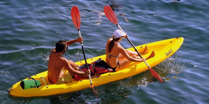 View of two tourists kayaking through serene waters