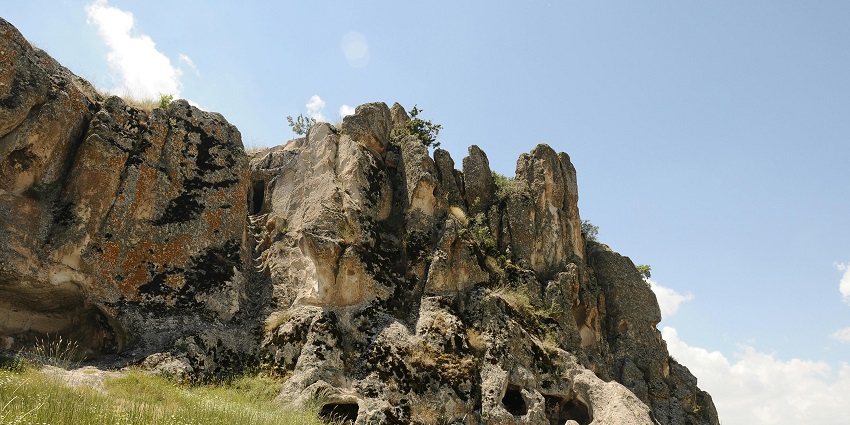 Low angle view of the Kukkal caves, surrounded by verdant landscapes