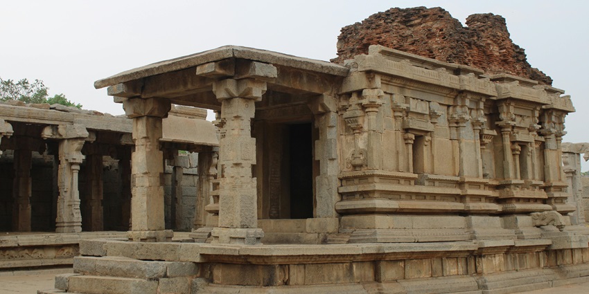 An image of an ancient temple with stone pillars and structures near Meenakshi Temple.