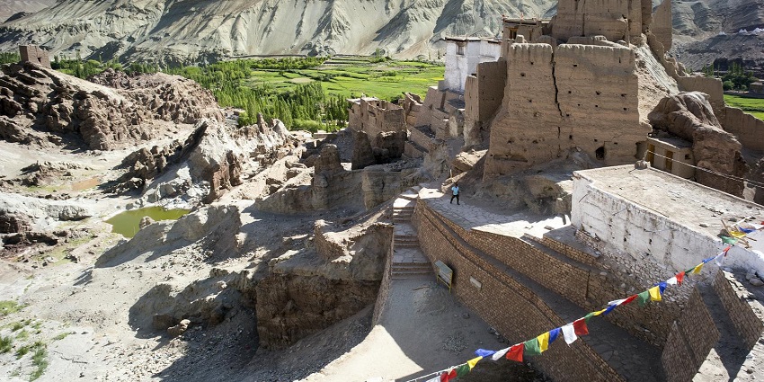 A view of Basgo Monastery in Ladakh, featuring traditional structures nestled among dramatic mountain scenery