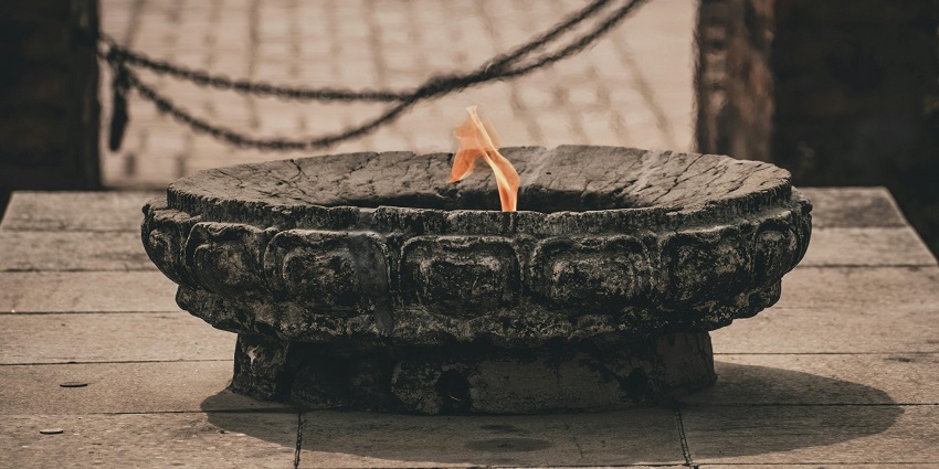 Image of flame in a temple designed with rocks and historical significance