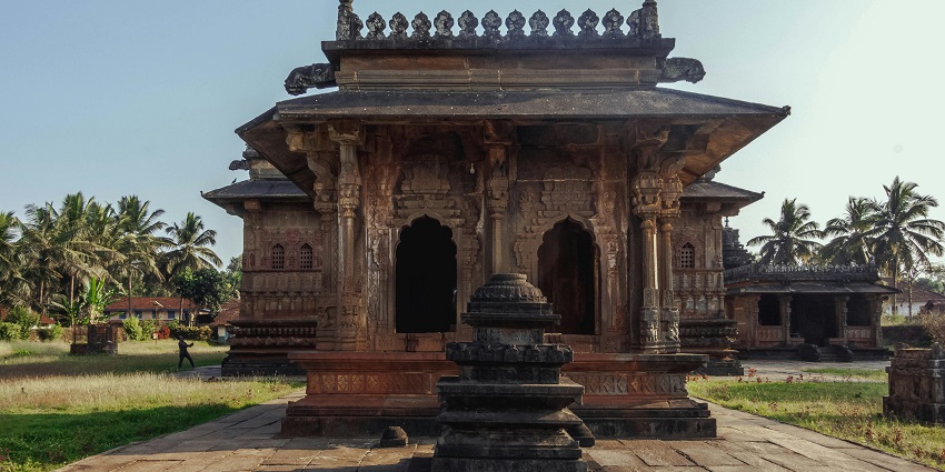 An ancient Hindu temple featuring ornate pillars and detailed sculptures near the lizard temple