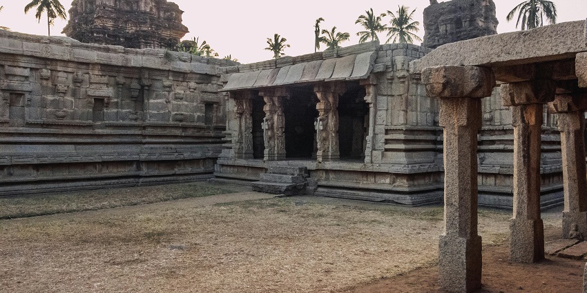 An Indian temple adorned with stone carvings features sculptures and architectural elements.